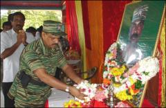 LTTE Special Commander Col. Balraj garlanding the photo of late LTTE commander Col. Ramanan.jpg