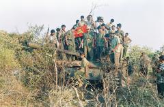 Balraj with fellow fighters on a Main Battle Tank seized by the Tigers in Iththaavil.jpg
