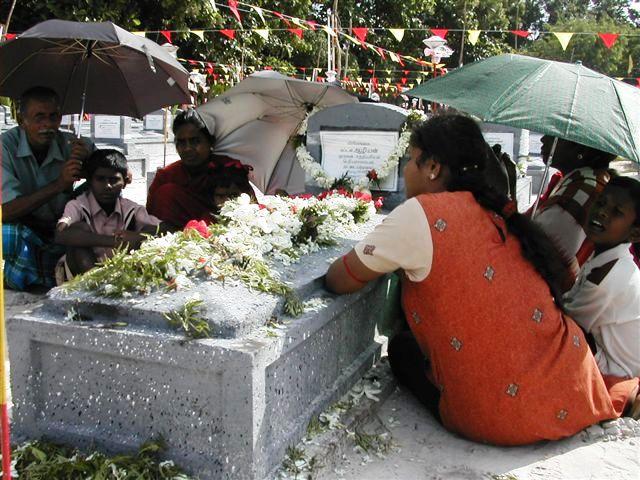 The relatives paying tribute their loved one in the hot sun.jpg