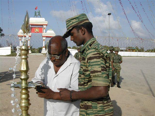Matryr Vaiko's father Sivam lights the oil lamp at the Elephantpass memorial site in early morning on Martyr's day.jpg