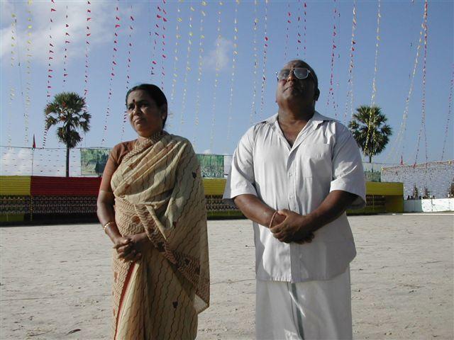 Martyr Vaiko's parents looking at the flag of Tamil Eelam being hoisted at the Elephantpass memorial site in early morning on Martyr's day.jpg