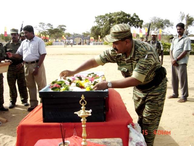 Colonel Sornam, Special Commander of the LTTE, garlanding the body of Lt.Murali, KIA on a Artilery fire.jpg