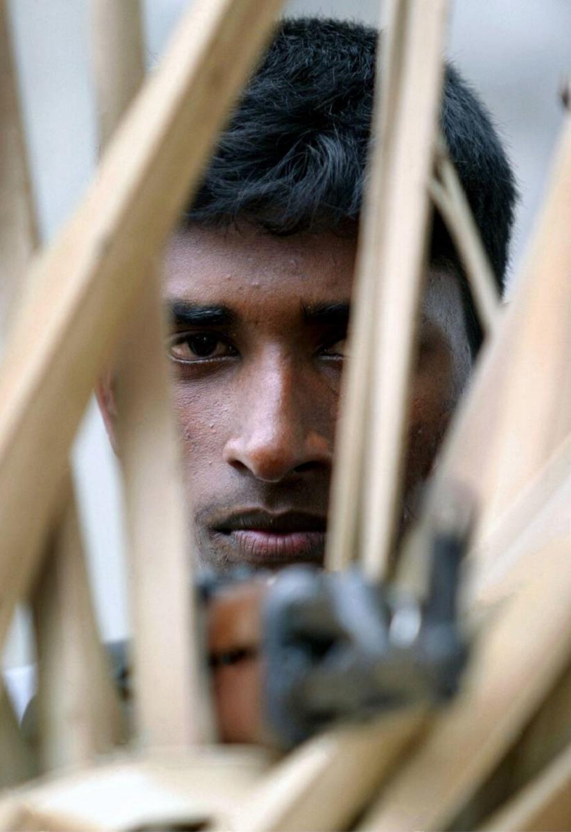 Tamil Tiger cadre with T-56 rifle... He is guarding a village in kokkattichcholai, Batti - July 7, 2004.jpg