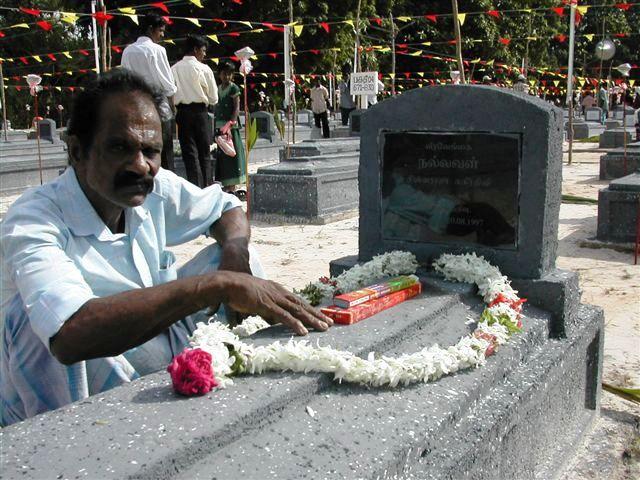 A father, who lost his daughter sits next her grave.jpg