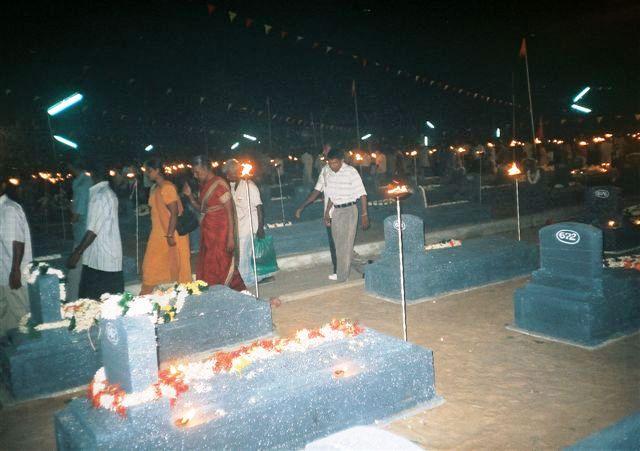 Relatives leave the Visuvamadu Martyr's graveyard after paying tribute to their loved ones.jpg