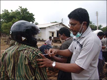 A cadre from LTTE's motorbike brigade being vaccined in the preperation of rescue operation.jpg