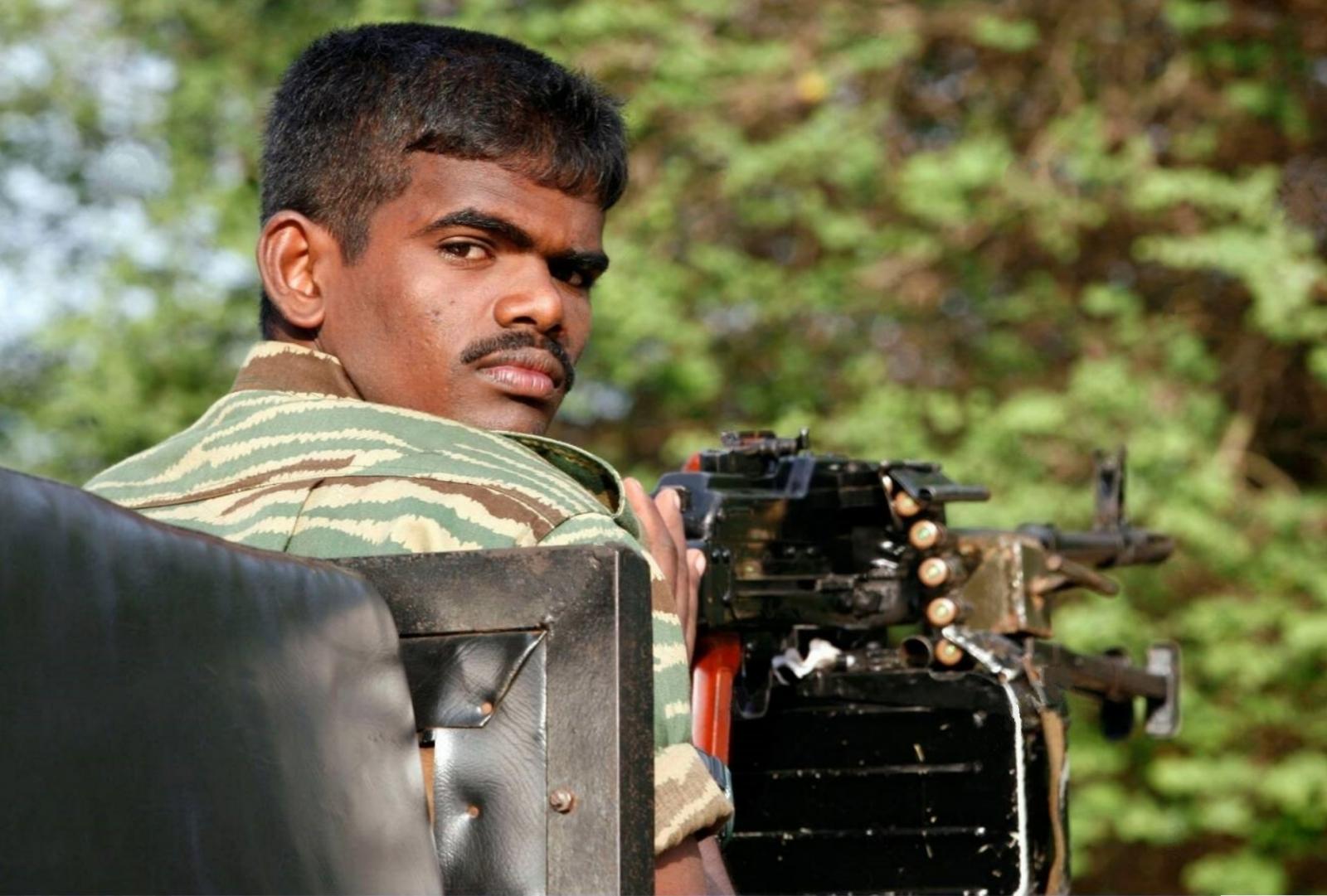 Tamil Tiger cadre on a Pickup during a patrol in Kilinochchi, rebels de-facto Tamil Eelam's capital.jpg