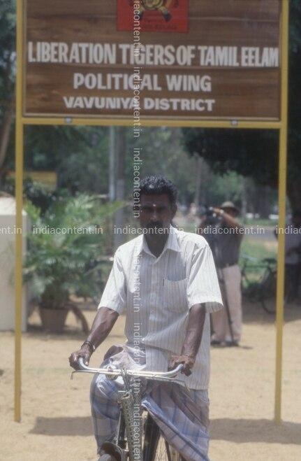 659-a-cyclist-standing-in-front-of-ltte-political-wing-vavuniya-image-F263SF9_DVD0111.jpg