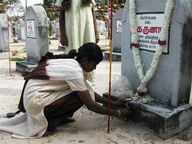 A female lighting incense sticks to her loved one.jpg