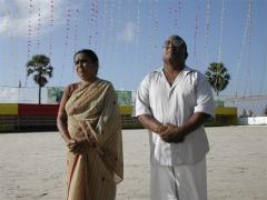 Martyr Vaiko's parents looking at the flag of Tamil Eelam being hoisted at the Elephantpass memorial site in early morning on Martyr's day.jpg
