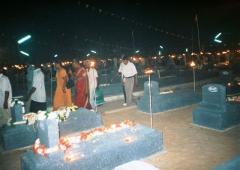 Relatives leave the Visuvamadu Martyr's graveyard after paying tribute to their loved ones.jpg