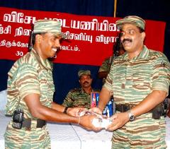 lttes-special-commander-for-trincomalee-col-sornam-right-hands-over-special-prize-to-mr-kilman-training-instructor.jpg