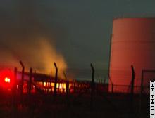 oiltank_01 Gas and Oil storage tanks in Keravelapitiya in Wattela, 10 km north of Colombo were hit, and three oil tanks are on fire, Wattela residents said..jpg