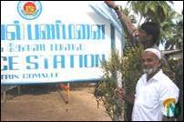 sampoor_policestation_1_081102 Mr.Alhaj S.M.Javabdeen, President of the Mutur Mosques Federation univeiling the name board of the Sampoor LTTE police station..jpg