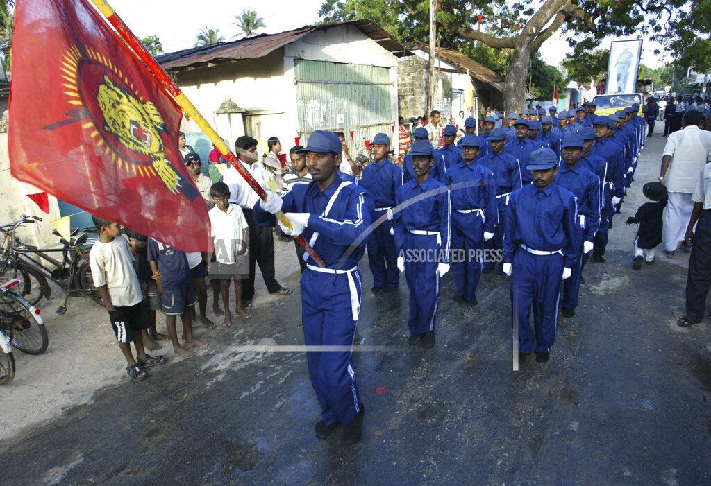 Nov. 26, 2005 file photo, members of a rebel volunteer youth force march with a flag of Tamil Eelam during a ceremony to celebrate the 51st birthday of rebel leader Velupillai Prabhakaran in Velvetithurai,.jpg