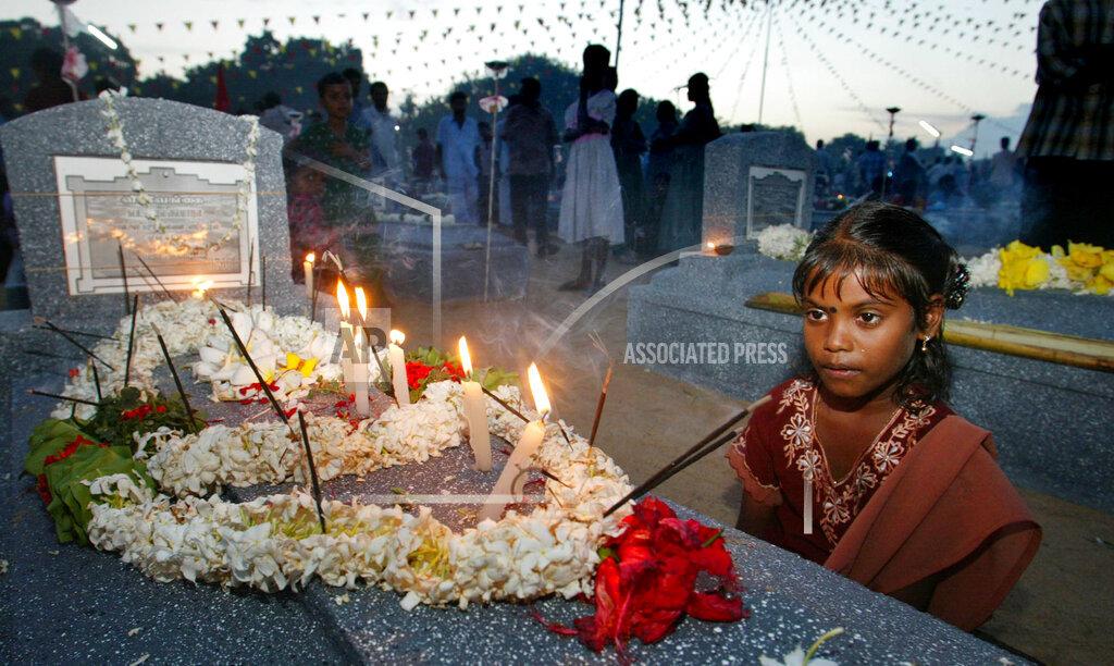 Debantry Sinduya looks at the grave of her uncle who lost his life fighting for the Liberation Tigers of Tamil Eelam, at Viswamadu cemetery, in rebel controlled town of Mulathivu  27, 2005.jpg