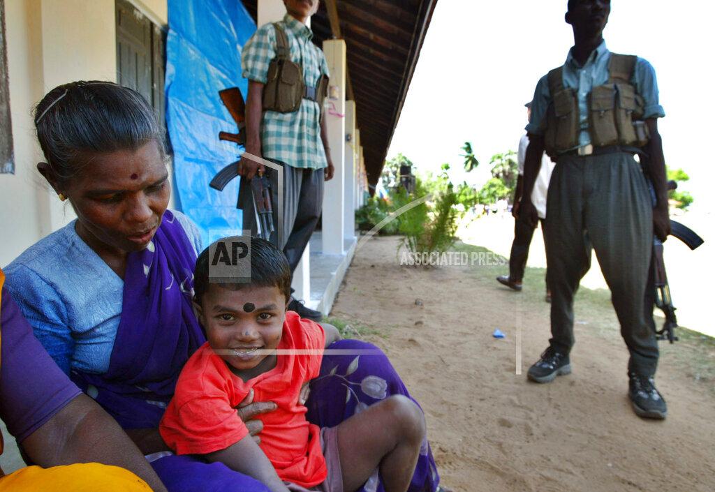 Ganesh, 5, a tsunami survivor smiles during his visit to an exhibition to mark the six-month anniversary of the 2004 tsunami at Tamil rebel-controlled town of Vakarai, june 26, 2005.jpg