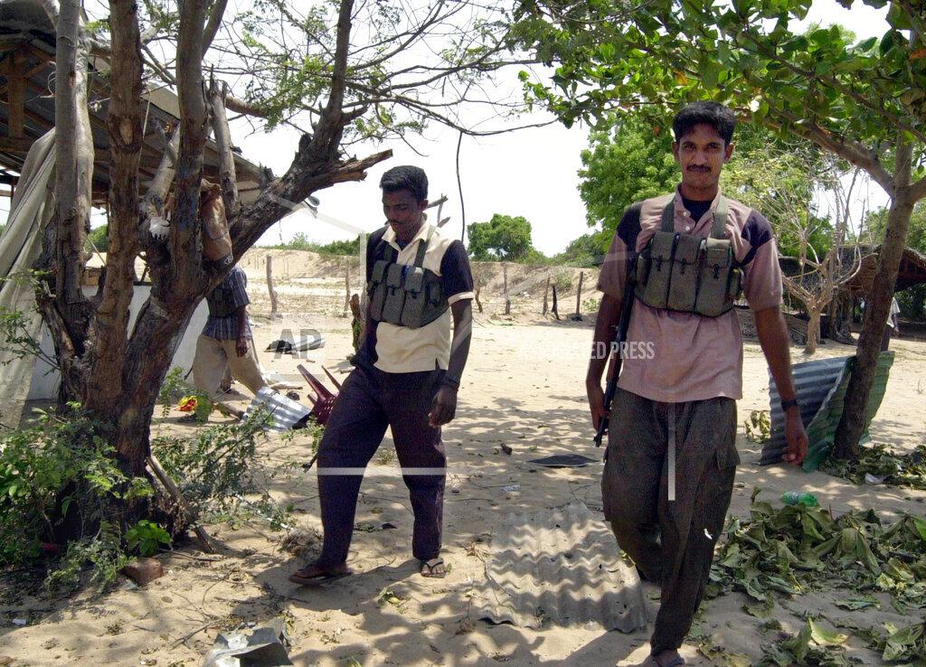 Tamil Tiger rebels stand guard at a training camp that was hit by a government airstrike in Sampur area of Trincomalee, april 28, 2006.jpg