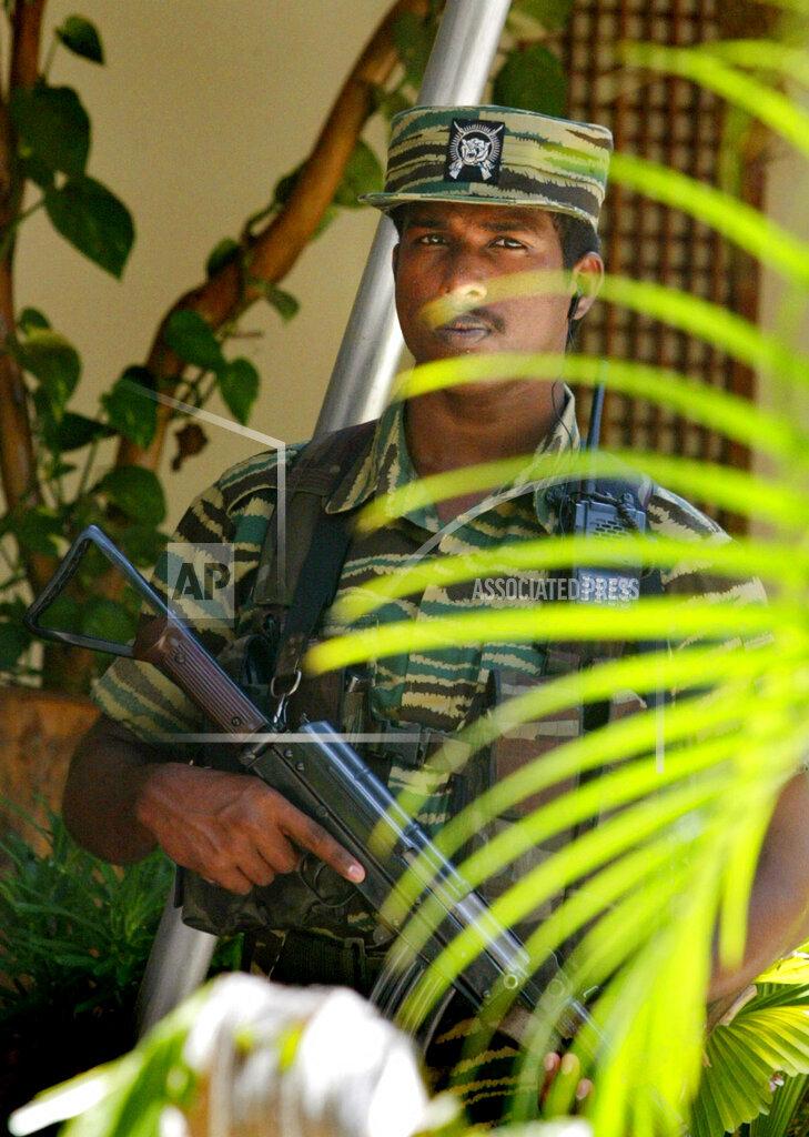 A Tamil rebel soldier stands guards during a meeting of leader of the Tamil Tigers' political wing S. P. Thamilselvan, and Norwegian peace envoy for Sri Lanka Jon Hanssen-Bauer, april 20 2006.jpg