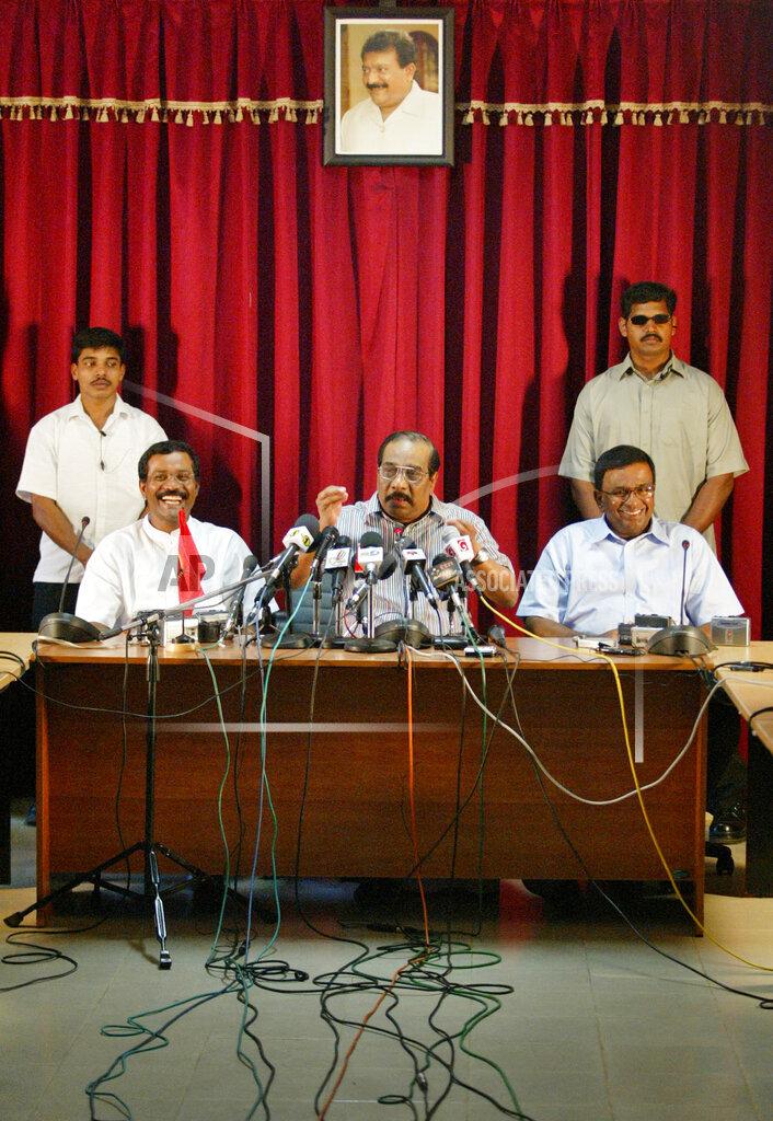 Chief negotiator and political strategist of Liberation Tigers of Tamil Eelam (LTTE), Anton Balasingham, center, speaks to media during a press conference at rebel-stronghold town of Kilinochchi, jan 25.jpg