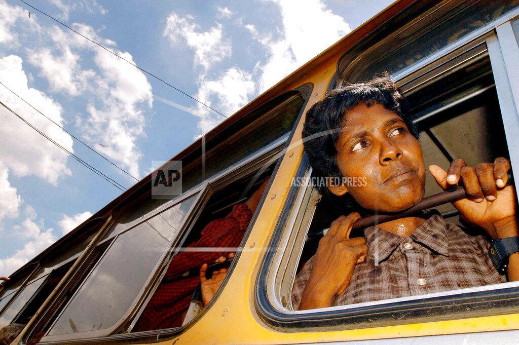 A young female Tamil Tiger rebel from the Karuna militia, a splinter guerrilla group that broke away from the mainstream Tamil Tiger rebels, waits in a city bus to return home in Batticaloa, eastern Sri Lanka, in this Apr.jpg