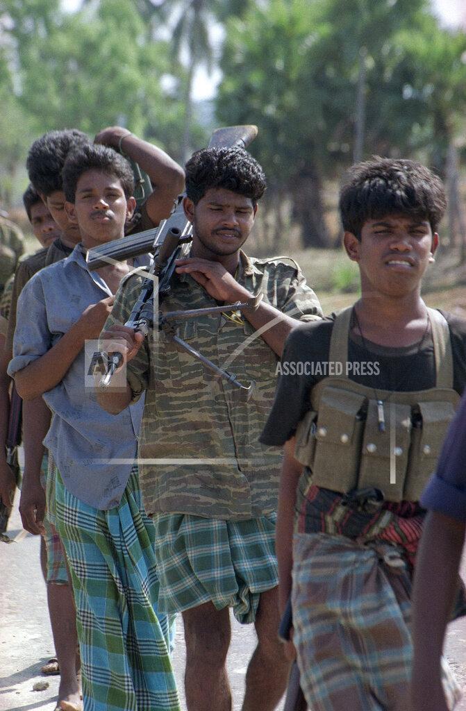 Barefoot rifle-slinging Tamil Tiger rebels patrol this eastern village in Karadiyawaru, Sri Lanka, Friday, August 27, 1990..jpg