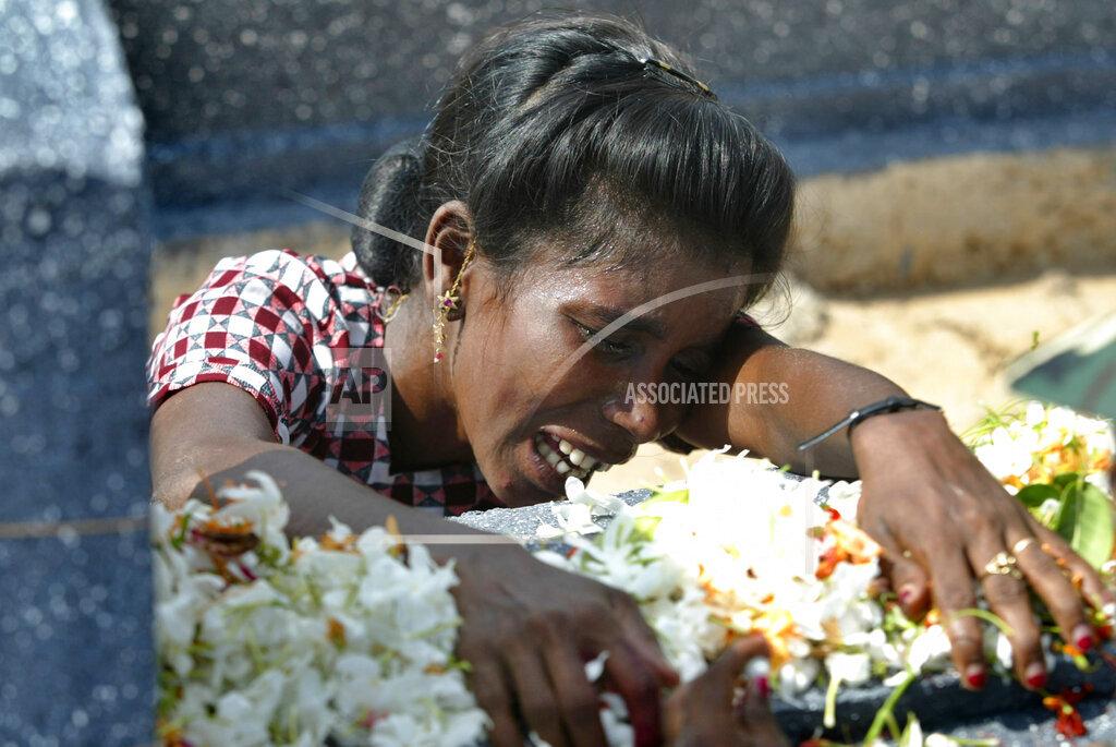 Ganasekaran Lusiya cries at the grave of her husband who lost his life fighting for the Liberation Tigers of Tamil Eelam, at Viswamadu cemetery, in rebel controlled town of Mulathivu  2005.jpg