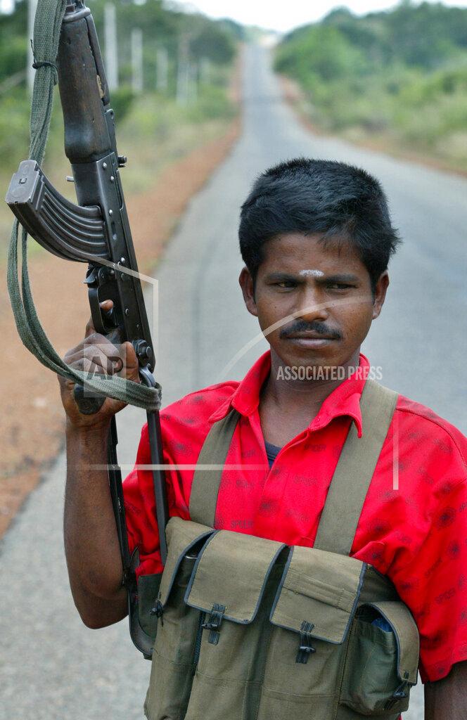 Tamil rebel Civil Forcee stands guard along the A9 highway, close to Mankulam, april 2007.jpg