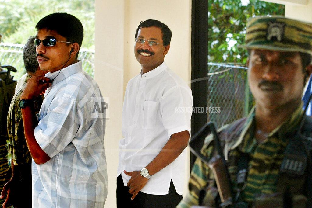 Leader of the Tamil Tigers' political wing S. P. Thamilselvan, second right, leaves with his security personnel after a meeting with Norwegian peace envoy for Sri Lanka Jon Hanssen-Bauer april 20.jpg