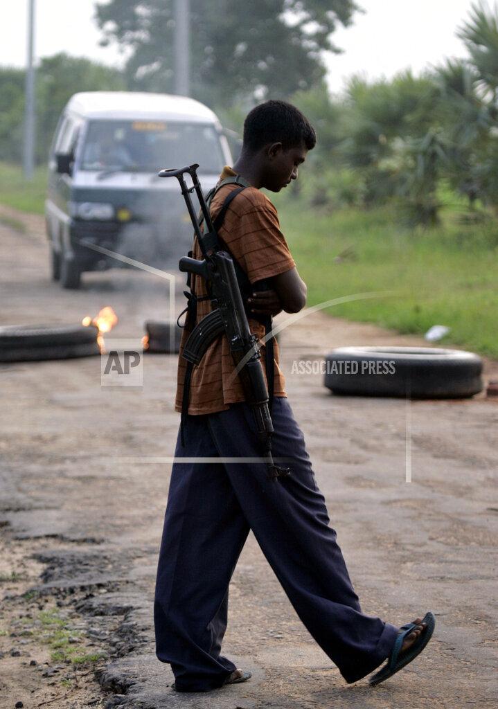 A soldier of Liberation Tigers of Tamil Eelam or LTTE mans a roadblock in Vavunathivu, in Batticaloa district of eastern Sri Lanka, Thursday, Nov. 17, 2005..jpg