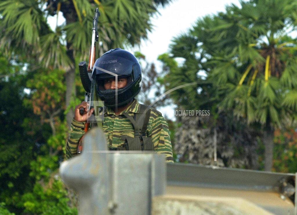A Tamil Tiger rebel fighter patrols a street leading to the guerillas military headquarters in Mullaitivu, june 14, 2005.jpg
