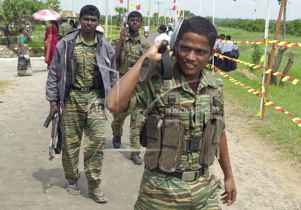 Tamil Tiger rebels patrol a street in rebel controlled eastern city of Karadiyanaru Nov 25, 2005.jpg