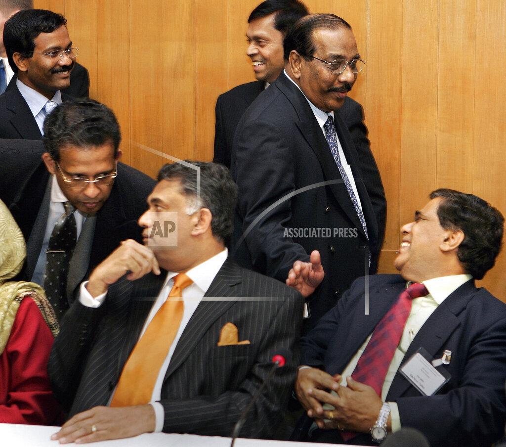 Go head of Delegation Nimal Siripala de Silva, foreground right, is greeted by LTT chief negotiator Anton Balasingham, second right, as UN Ambassador for Sri Lanka in New York Prasad Kariya left, Eco Rohita Bogollagama, 2nd left,.jpg