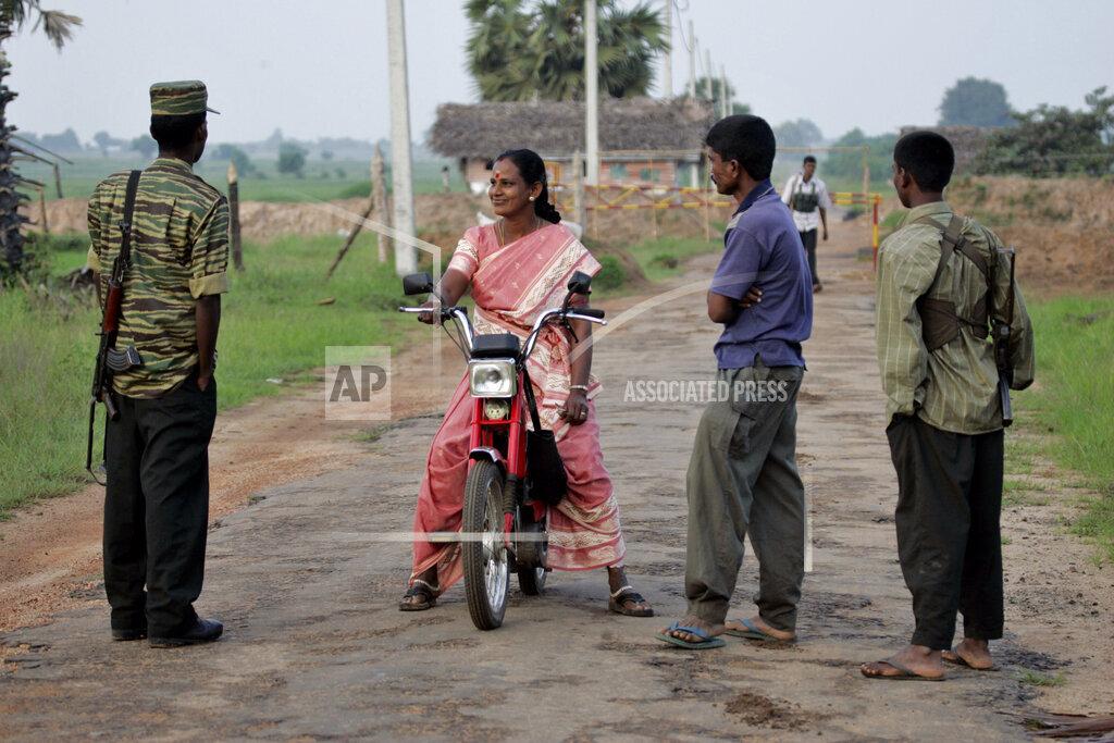 Soldiers of Liberation Tiger of Tamil Eelam or LTTE prevent a Tamil poll worker from crossing a roadblock at Vavunathivu, in Batticaloa district of eastern Sri Lanka, Thursday, Nov. 17, 2005..jpg