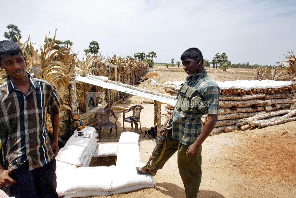 Tamil Tiger rebels stand guard at the forward defense lines of rebel controlled Batticaloa june 30, 2006.jpg