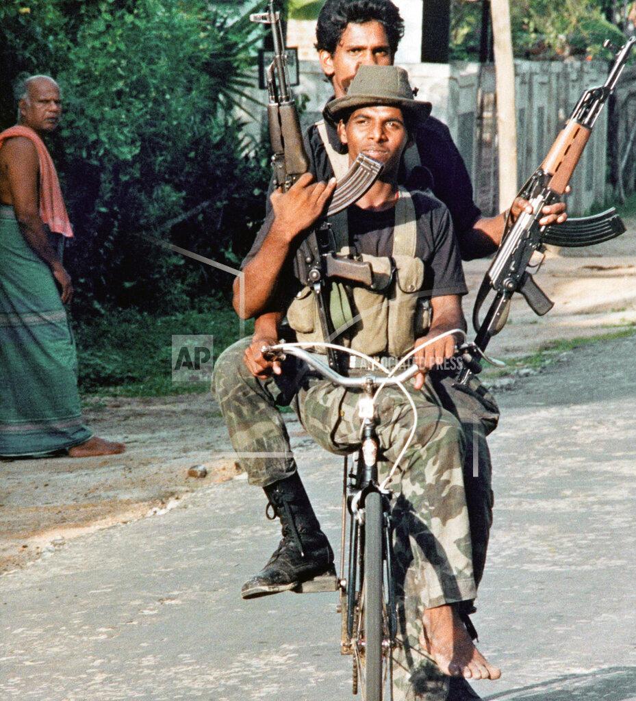 Tamil Tiger rebels on a bicycle patrol the streets of this eastern town, Thursday, Nov. 24, 1989,.jpg