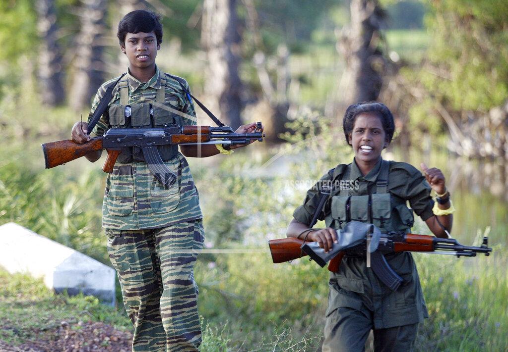 Uniformed woman cadres of the Liberation Tigers of Tamil Eelam patrol in the rebel controlled town of Mulathivu  nov 27, 2005.jpg