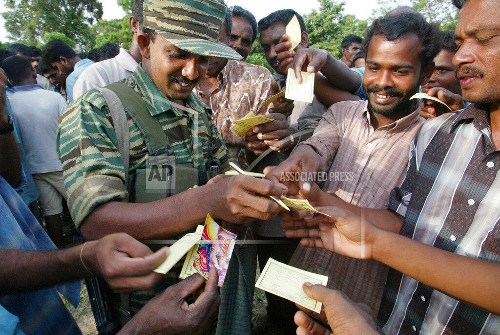 A Tamil rebel fighting instructor marks attendance of participants in a training for Tamil civilians living in rebel controlled village of Udayanagar, near Kilinochchi, may 17.jpg