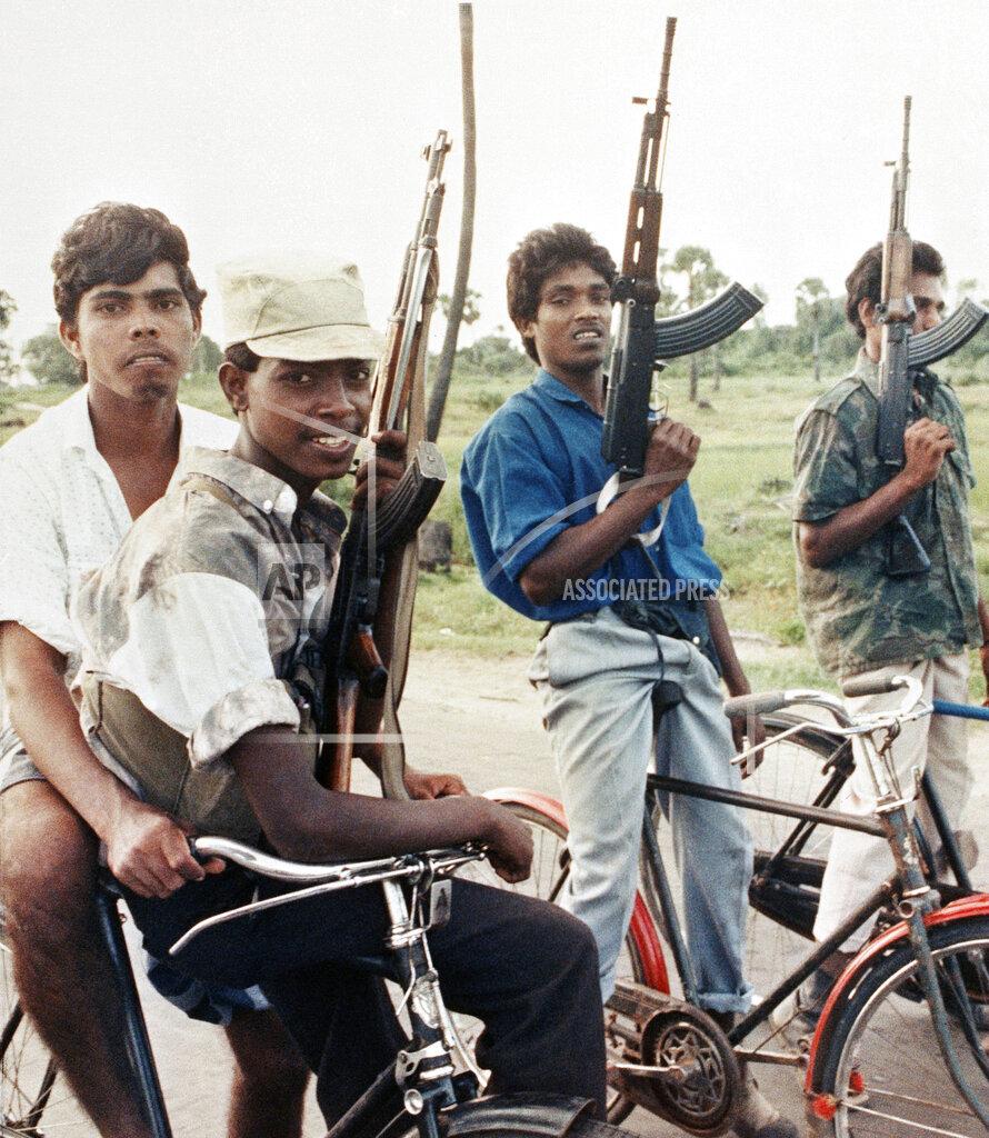 Young Tamil Tiger rebels armed with AK-47 rifles patrol the eastern town of Batticaloa on Dec. 17, 1989, a day after they seized it from the Tamil National Army(Pro-IPKF))