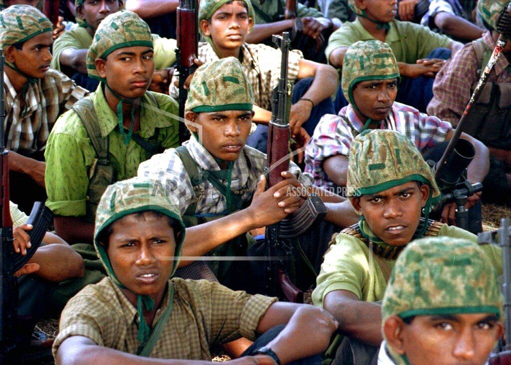 Tamil Tiger rebel recruits listen to lectures at a jungle training camp at Vakarai village in eastern Batticaloa district Monday, August 12, 1996..jpg