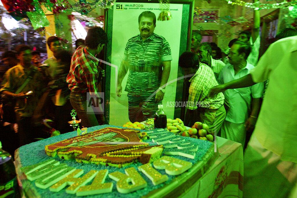 Supporters of Tamil Tiger rebels put up a portrait of Tamil Tiger leader Velupillai Prabhakaran, in the house were Prabhakaran was born, during his 51st birthday celebrations in Velvetithurai 2005.jpg
