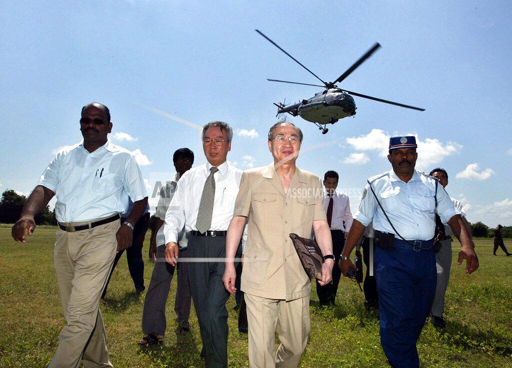 Japanese peace envoy Yasushi Akashi, second right, arrives for talks with Tamil Tiger rebels along with S. Pullithevan Chief of peace secretariat of Tigers, left, and Japanese ambassador Akiyo Suda, second left, may 9 2006.jpg