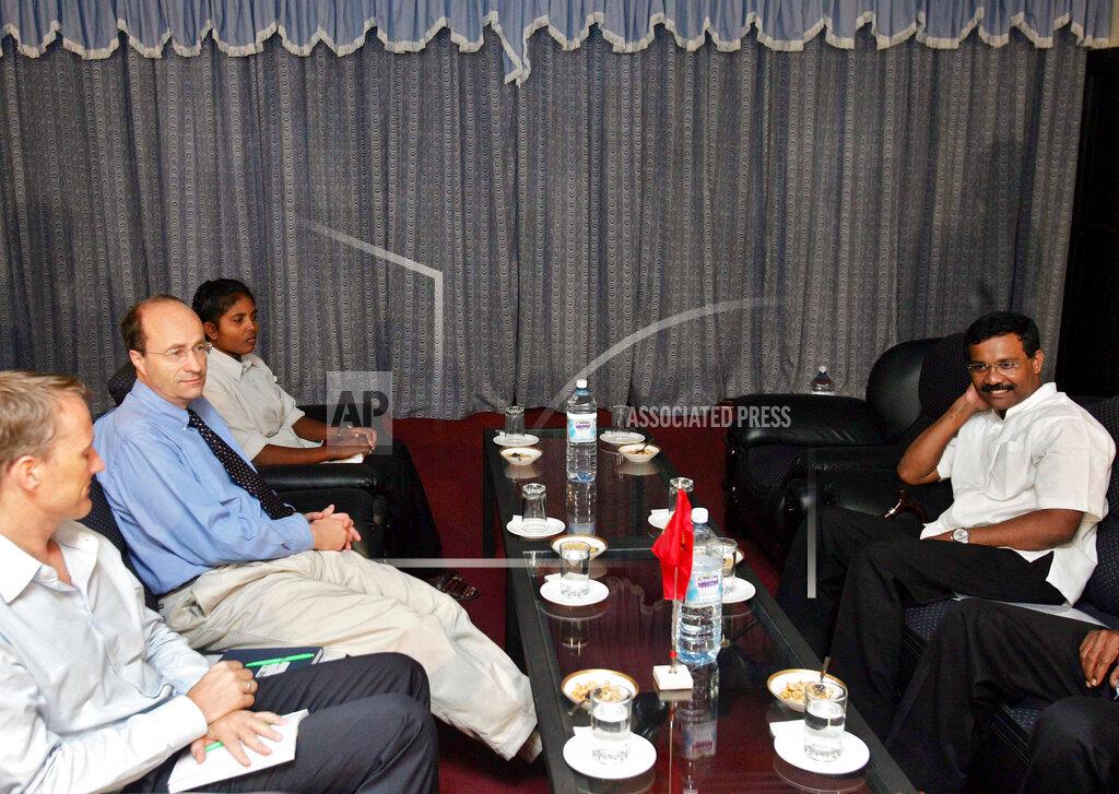Political chief of the Tamil Tiger rebels S.P. Tamilselvan, right, talks with Norway ambassador to Sri Lanka, Hans Brasttar, second left, during a meeting in Kilinochchi, june 21 2006.jpg