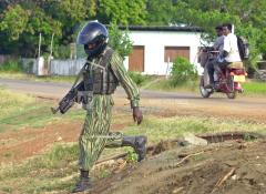 A Tamil Tiger rebel fighter patrols a street leading to the guerillas military headquarters in Mullaitivu,  june 14, 2005.jpg