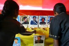 A photograph of Tamil rebel leader Velupillai Prabhakaran and a cake is seen in the foreground as supporters of Tamil rebels celebrate the 51st birthday of the rebel leader in Sakkotai, in northern Jaffna peninsula, 2005.jpg