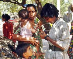A young child Tamil Tiger cadre, right, from the Karuna militia, a splinter guerrilla group that broke away from the mainstream Tamil Tiger rebels, returns to her family in the village of Kothiapula, 18 kilometers from.jpg