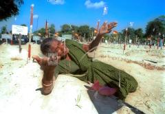 An unidentified Tamil woman cries on the grave of her son, killed in fighting with government forces, at a cemetery in Mullathivu, 2002 no.jpg