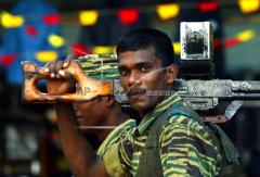 A Tamil Tiger soldier who arrived in to the main Tamil controled town to honor slain comrades moves through the streets as preparations for Martyr's day kili nov 26, 2003.jpg