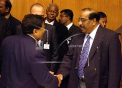 Anton Balasingham, right, chief negotiator and political strategist of Liberation Tigers of Tamil Eelam (LTTE), shakes hands with Nimal Siripala De Silva, left, Sri Lanka's chief negotiator,.jpg