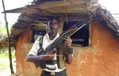 A Tamil Tiger rebel guards an outpost in rebel controlled eastern city of Karadiyanaru nov 25, 2005.jpg